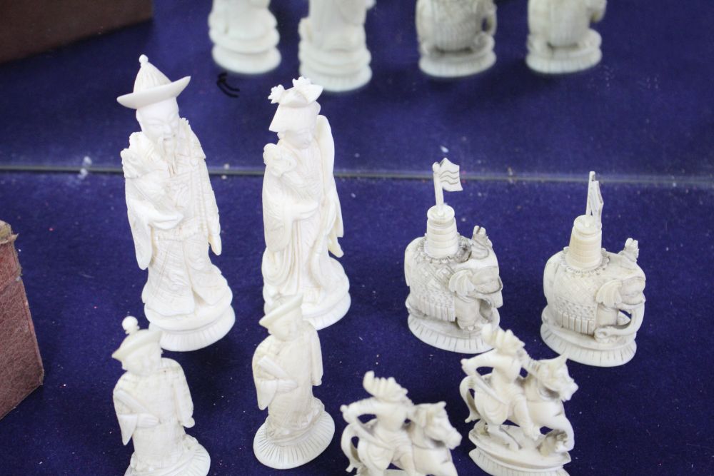 An early 20th century Chinese carved and red stained ivory chess set, carved as opposing Chinese armies, king 12cm